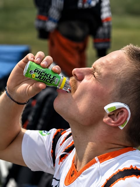 An RIT player drinks pickle juice on the sideline